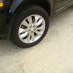 Before and after photographs of a damaged, black, Range Rover that was repaired by Elite Paint & Body Shop in West Palm Beach, FL.